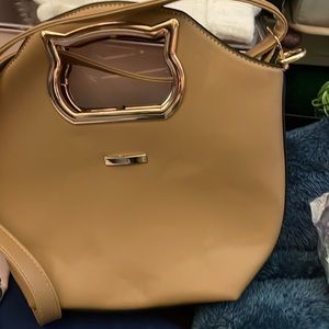 Tan over the shoulder handbag with zippered closure